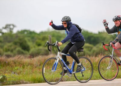 Cyclists riding bikes, enjoying outdoor adventure on Bluebonnet Express route.