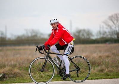Vegan cycling enthusiast riding a road bike along a scenic trail.