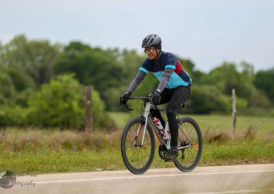 Bright bluebonnet express bike in action on scenic outdoor trail for cycling enthusiasts.