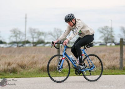 Bluebonnet Express bicycle ride, cyclist wearing helmet, outdoor biking event, Texas scenic route.