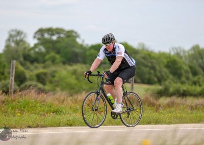 Velo rider on Bluebonnet Express bike in outdoor countryside setting for cycling adventure.