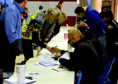 1. Biking event registration table with diverse participants, showing community engagement.