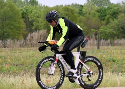 High-performance electric bike rider on Bluebonnet Express trail, showcasing advanced cycling technology.