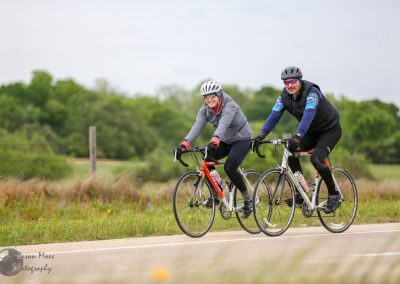 Vibrant cyclists riding bikes along a scenic rural trail, enjoying outdoor fitness and adventure.
