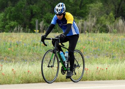 Vibrant cyclist riding a bike on scenic trail during daytime.