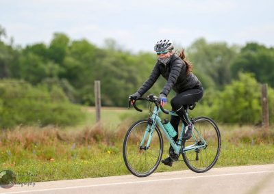 Bike touring on Bluebonnet Express scenic route, woman cycling outdoors.
