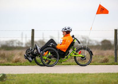 All-terrain adaptive recumbent bike for accessible outdoor activity, designed for riders with mobility challenges.