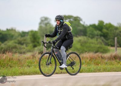 Bright bluebonnet express bike with cyclist riding through scenic outdoor trail in Texas.