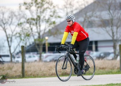 Rider in Red and Yellow Riding Bicycle Outdoors during Bluebonnet Express Event.
