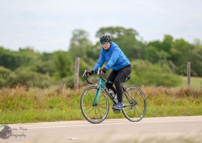 Comfortable cyclist enjoying outdoor ride on Bluebonnet Express bike trail, wearing gear for cycling adventure.