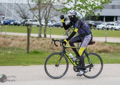Vibrant cyclist riding a Black and Yellow Focus road bike during Bluebonnet Express event.