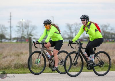 Bright yellow cycling jackets, helmets, and gear during Bluebonnet Express bike ride event.