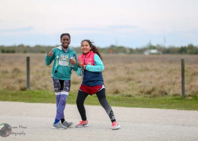 Vibrant cyclists with backpacks enjoying outdoor adventure on Bluebonnet Express trail.