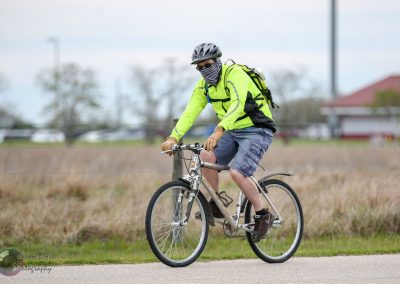 Bright yellow safety jacket worn while riding bike on scenic trail.