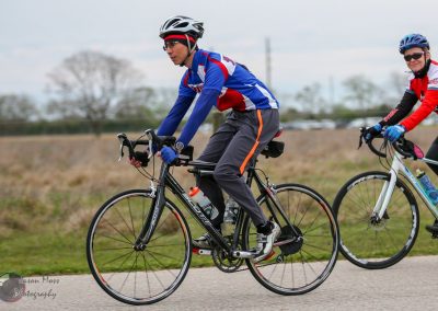 Vibrant cyclists riding Bluebonnet Express bikes on scenic outdoor trail, enjoying bike ride.