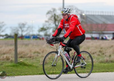 Bright cyclist riding a bicycle, participating in Bluebonnet Express event, outdoor cycling, Texas.