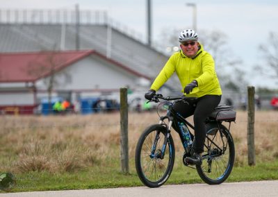 Bright yellow jacket biker enjoying outdoor cycling on Bluebonnet Express route.