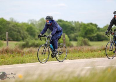 E-bike riders enjoying scenic outdoor trail with lush greenery, premium Bluebonnet Express bikes, outdoor biking adventure, Texas landscape.