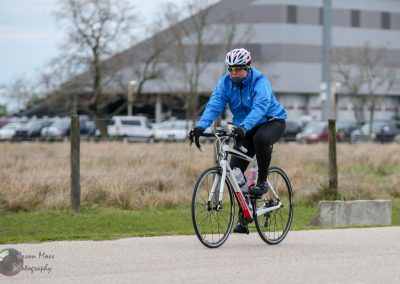 Comfortable cyclist riding an e-bike outdoors on a cloudy day.