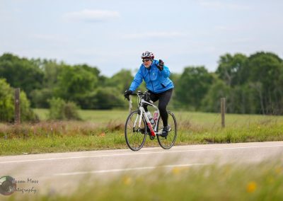 Cyclist on a scenic trail, promoting Bluebonnet Express bike transportation service.