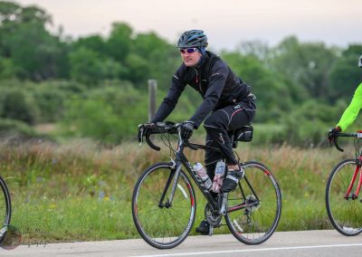 High-performance cycling bike with rider on scenic trail for Bluebonnet Express event.