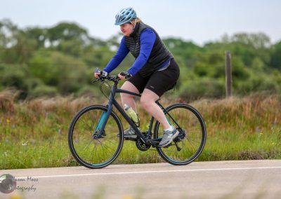 Bright blue and black electric mountain bike on a rural trail, perfect for eco-friendly outdoor commuting.