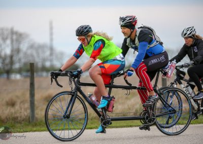 High-speed tandem bike ride on Bluebonnet Express trail with multi-rider cycling team.