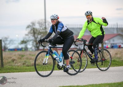 Brightly dressed cyclists enjoying a scenic ride on the Bluebonnet Express bike trail.