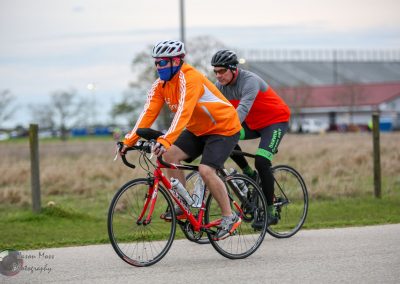 Bright orange cycling jacket on rider during Bluebonnet Express ride cycling event.