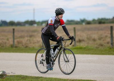 Mountain biking adventure on Bluebonnet Express trail amidst scenic rural landscape.