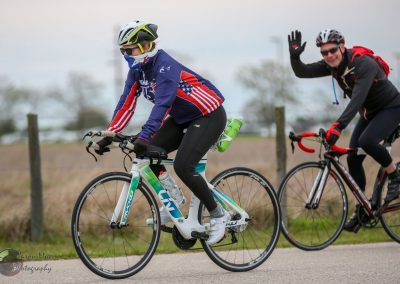Brightly dressed cyclists enjoying outdoor riding on a scenic trail with Bluebonnet Express bikes.
