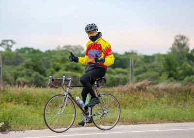 Bright cyclist on a vintage bike during Bluebonnet Express race in Texas, showcasing scenic rural views.