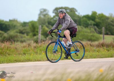 Vibrant cyclist enjoying scenic ride on Bluebonnet Express trail in Texas.
