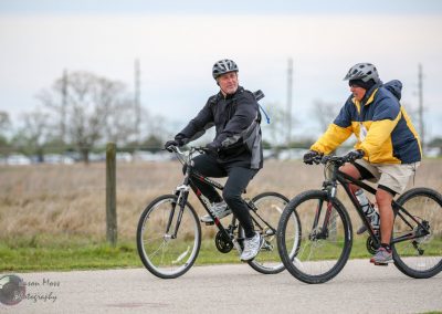 Active cyclists riding bikes outdoors during daytime for fitness and recreation.