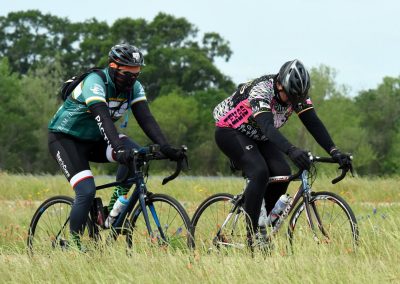 High-performance cycling team riding on Grass field in Texas with Bluebonnet Express jerseys.