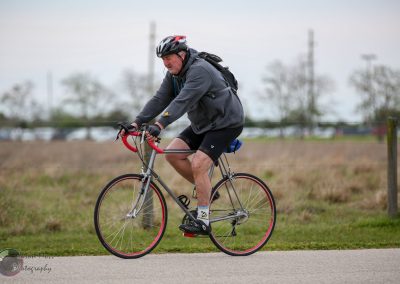 Comfortable cyclist riding during Bluebonnet Express bike event in outdoor rural setting.