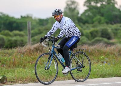Bright blue bicycle riding through scenic countryside on Bluebonnet Express route.
