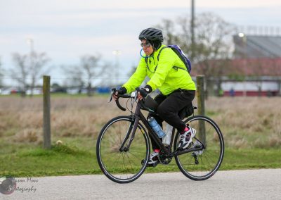 Bright yellow waterproof cycling jacket on rider for Bluebonnet Express bike ride.