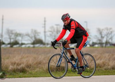 High-performance cyclist riding Bluebonnet Express road bike outdoors.