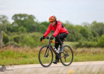 High-performance cyclist riding a Trek electric bike on scenic rural road for eco-friendly transportation.