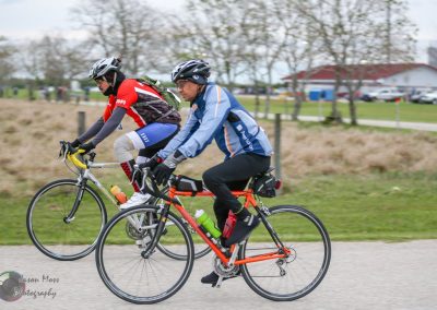 Active cyclists riding bikes on a scenic outdoor trail in Texas, promoting Bluebonnet Express bike tours.