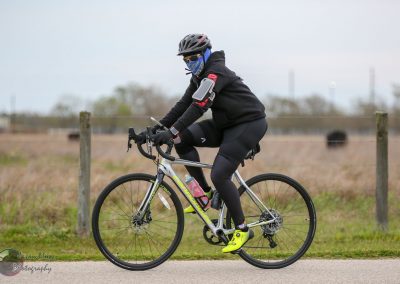 High-performance cyclist riding a Specialized bicycle on a scenic outdoor trail.