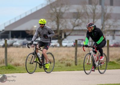 Bright yellow helmet and cycling gear on male cyclist riding Bicyle outdoors during daytime.