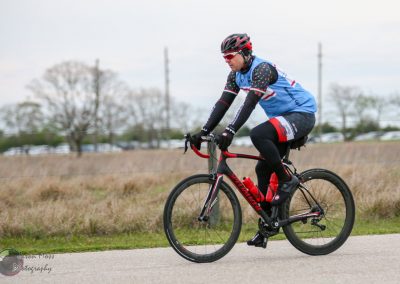 Bright blue cyclist jersey on a mountain bike during daytime ride.