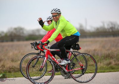 Vibrant cycling team riding on a scenic trail, promoting the Bluebonnet Express with high-performance bikes.