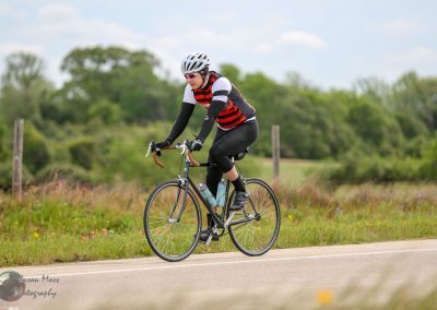 Nature cycling with Bluebonnet Express, outdoor bike ride on scenic rural road.