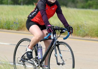 High-performance biking on Bluebonnet Express cycling trail, female cyclist enjoying outdoor adventure.
