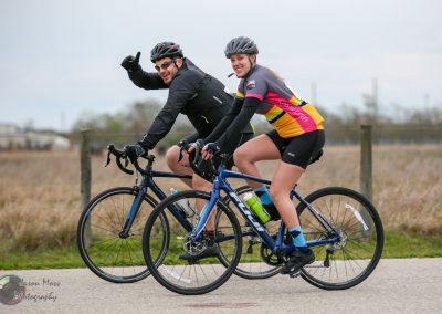 Enjoying a scenic ride on Bluebonnet Express cycling route with friends, experiencing Texas' beautiful landscape and cycling trails.