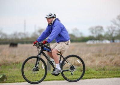 Electric bike ride in rural landscape with Bluebonnet Express branding, eco-friendly cycling, Texas bike tour.