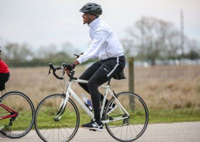 Comfortable cyclist riding a bike on a scenic outdoor trail | Bluebonnet Express cycling tour.